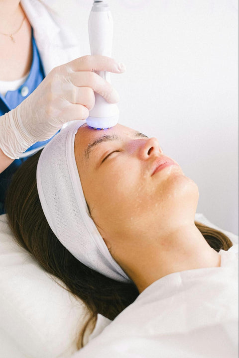 A woman receives a microcurrent facial treatment.